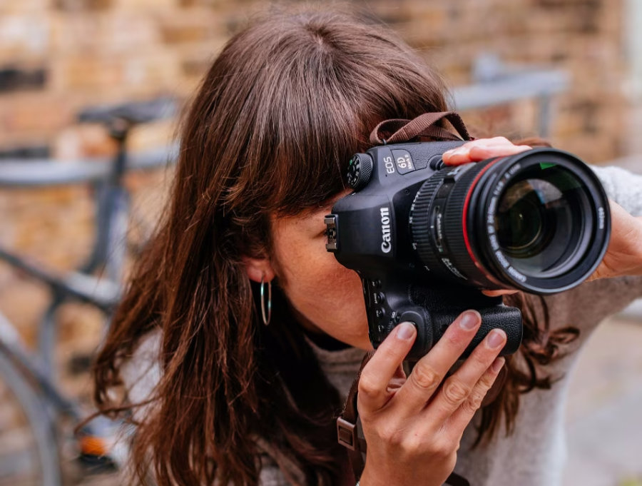  Photograph of Canon EOS 6D Mark II DSLR held by photographer<